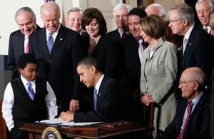 President Barack Obama signs the Affordable Health Care for America Act during a ceremony with fellow Democrats in the East Room of the White House March 23, 2010 in Washington, DC. The historic bill was passed by the House of Representatives Sunday after a 14-month-long political battle that left the legislation without a single Republican vote.