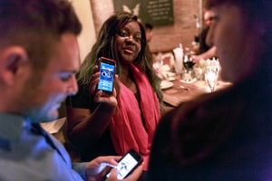 Patrons use Tinder, the online dating app, while at Bondurants, a bar in New York, Feb. 5, 2015. Tinder, the dating app that replaced profiles and algorithms with streams of photographs, has become a fixture of the online dating scene.