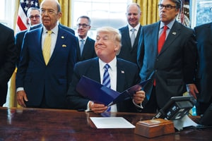 President Donald Trump, flanked by Commerce Secretary Wilbur Ross, left, and Energy Secretary Rick Perry, is seen in the Oval Office of the White House in Washington Friday, March 24, 2017, during the announcing of the approval of a permit to build the Keystone XL pipeline, clearing the way for the $8 billion project.