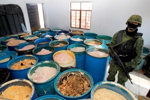A Mexican soldier stands on guard at the Villareal farm, where more than 15 tons of methanphetamine were found, in Tlajomulco, Jalisco state, Mexico, 09 February 2012. Soldiers also found 4575 liters of chemicals and 2400 kilos of caustic soda.