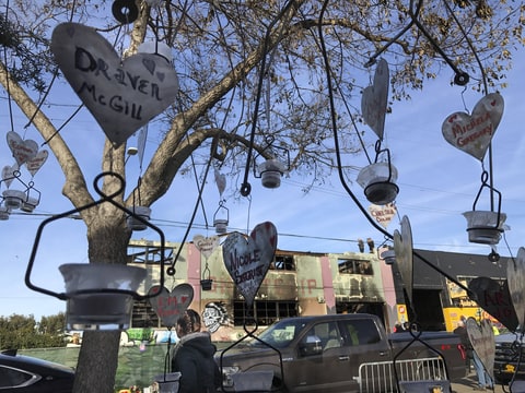 Oakland, California, USA - Ghost Ship Warehouse Dec. 12, 2016...A metal Willow tree holding hearts with names and notes (including the parents of Nicole Siegrist) across the street from the Oakland Warehouse, named Ghost Ship, where 36 people died. The sculpture was the concept of Willow Mahoney and made by Steel Work in Santa Clara.
