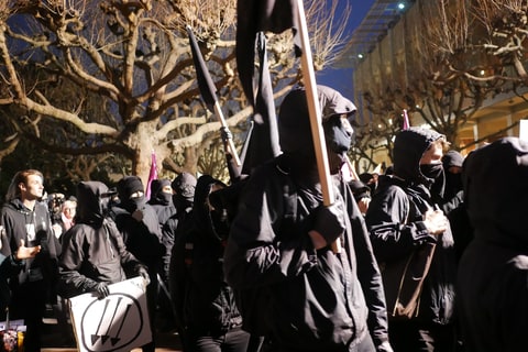 February 1, 2017 - Berkeley, California, U.S - Anti-fascist protesters dressed in black arrive at a protest on the University of California-Berkeley campus against Milo Yiannopoulos, a Breitbart writer who has grown notorious for his comments targeting women and minorities. Yiannopoulos was scheduled to speak Feb. 1 at the invitation of College Republicans but he left the campus an hour-and-a-half before his scheduled talk as protesters grew unruly, throwing objects and setting off a bonfire