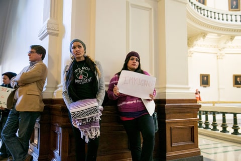 AUSTIN, TEXAS - December 19, 2016: Margeaux Maledon, 29, (left) and Miriam Rivero, 22, (right) holds a sign reading