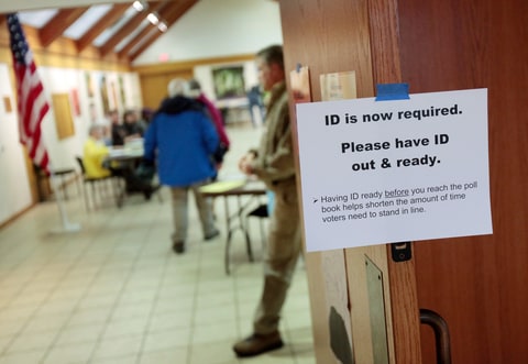 A sign informs voters of the need for identification at the Olbrich Gardens polling location in Madison, Wis. Tuesday, Feb. 16, 2016. The Supreme Court election was the only statewide race in Tuesday’s primary, which included scattered county and municipal races. Turnout was projected at only around 10 percent. A photo ID was required to vote, a new requirement stemming from a law first passed in 2011 but eventually put on hold until it was upheld by the state Supreme Court in one of several rulings seen as partisan in recent years.