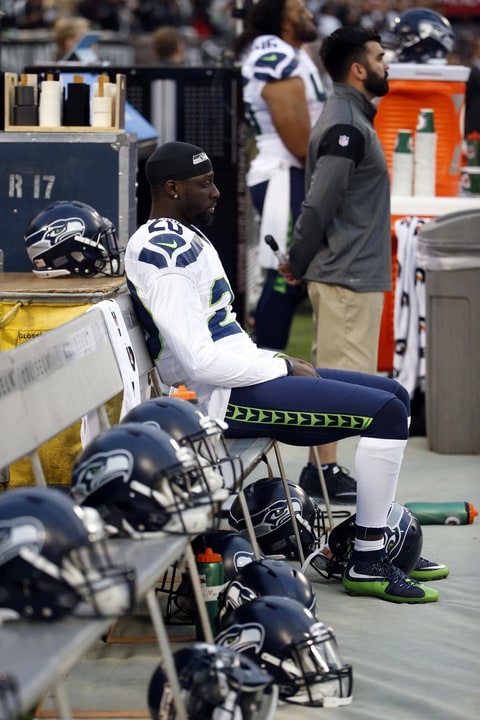 Seattle Seahawks cornerback Jeremy Lane sits as the national anthem plays before a preseason NFL football game against the Oakland Raiders, Thursday, Sept. 1, 2016, in Oakland, Calif. (