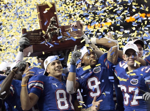 Aaron Hernandez (81), Louis Murphy (9) and Butch Rowley (37) celebrate after receiving the SEC Championship Trophy following a 31-20 win over top-ranked Alabama in the Southeastern Conference Championship NCAA college football game at the Georgia Dome in Atlanta. Hernandez, who was serving a life sentence for a murder conviction and just days ago was acquitted of a double murder, died after hanging himself in his prison cell Wednesday, April 19, 2017, Massachusetts prisons officials said.