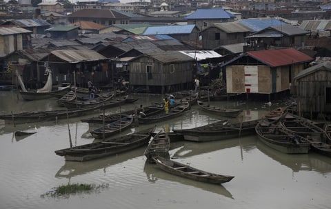 Children play aboard a fishing canoe on the waterfront of the Makoko neighborhood in Lagos, Nigeria, Thursday, July 20, 2017. On Tuesday July 18, U.S. Ambassador to the U.N Nikki Haley sharply criticized African nations for what she called a