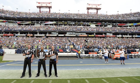 Officials stand on the sideline of the Seattle Seahawks during the playing of the national anthem before an NFL football game between the Seahawks and the Tennessee Titans Sunday, Sept. 24, 2017, in Nashville, Tenn. Neither team came out onto the field for the anthem.