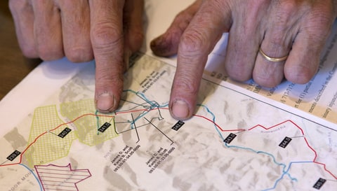 Jim Scott points to where the proposed Mountain Valley Pipeline, shown in red, would pass through his family's land, Friday, Dec. 1, 2017. The Scotts have submitted written comments to the state.