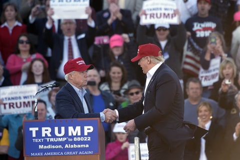 Republican presidential candidate Donald Trump, right, stands next to Sen. Jeff Sessions, R-Ala., as Sessions speaks during a rally Sunday, Feb. 28, 2016, in Madison, Ala.