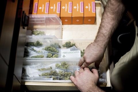 JP Noda stocks cannabis at The Apothecarium shortly before the store opened for its first day of recreational marijuana sales on Saturday, Jan. 6, 2018, in San Francisco. An announcement that the Department of Justice would no longer adopt a