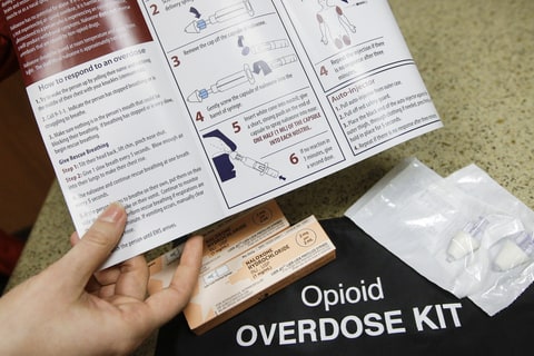 In this Tuesday, Dec. 22, 2015, photo, pharmacist Julia Landis, of Fort Hamilton Hospital, displays an opioid overdose kit in Hamilton, Ohio. Chief medical officer Dr. Marcus Romanello said the emergency room averages more than an overdose patient a day. F.O.R.T (Fort’s Opiate Recovery Taskforce) began late last year, involving police and other first responders, therapists, a social worker, and a hospital pharmacist to help steer them into treatment and provide resources to their families.