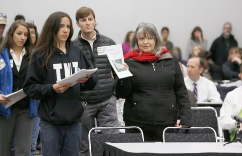 Anti-fracking activists led by Xiuhtezcatl Martinez, left, of Earth Guardians, and Karen Dike, a retired registered nurse from Longmont, Colo., present studies to members of the Oil and Gas Task Force as they meet to put the final touches on recommendations for Colorado Gov. John Hickenlooper to consider in the settlement of disputes over oil and gas drilling Tuesday, Feb. 24, 2015, in Denver. The meeting comes as some activists have renewed a campaign to banning the use of hydraulic fracturing in the state.