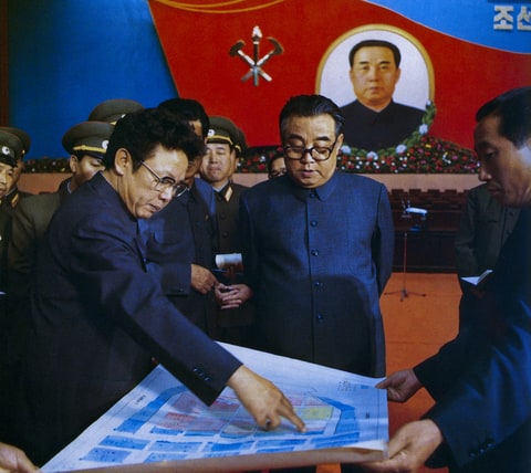 In this October 1980 photo from North Korea's official Korean Central News Agency, distributed by Korea News Service, leader Kim Il Sung (right) and Kim Jong Il debate about the preparation for the 6th Rally of Workers' Party of (North) Korea. (Korean Central News Agency/Korea News Service via AP Images)