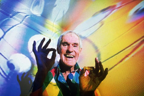 Timothy Leary, the former LSD experimenter turned computerized hallucination designer, is photographed in his Beverly Hills, Ca., home in July 1992 with video images from his show projected over him.