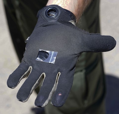 A country sheriff holds a small bag containing black tar heroin in New Mexico.