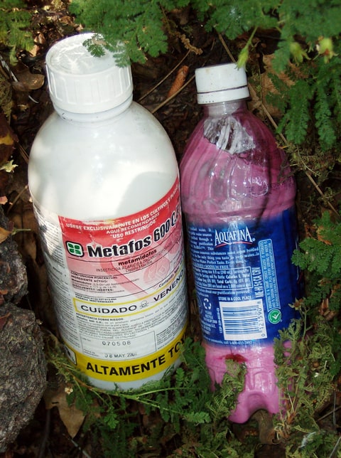 In this undated photo provided by the California Department of Fish and Wildlife, are bottles of chemicals left at a public land marijuana grow in California's central valley. California pot growers choosing to go legal in the New Year will face a host of new environmental rules and regulators. State officials say the problems with black-market grows include eroding vulnerable habitat, diverting streams and illegal use of pesticides.