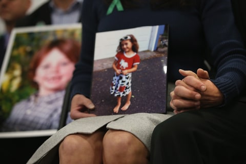 Parents of Sandy Hook Elementary massacre victims hold hands during a press conference on the one month anniversary of the Newtown elementary school massacre on January 14, 2013 in Newtown, Connecticut. Eleven families of Sandy Hook massacre victims came to the event one month after the shooting to give their support to Sandy Hook Promise, a new non-profit with the goal of preventing such tragedies in the future.