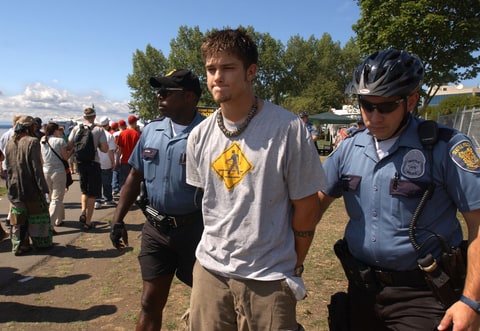 Seattle police take into custody a man suspected of selling marijuana at Hempfest August 16, 2003 in Seattle. Hempfest is the largest rally and festival advocating marijuana drug war reforms in the world and was expecting over 170,000 participants.