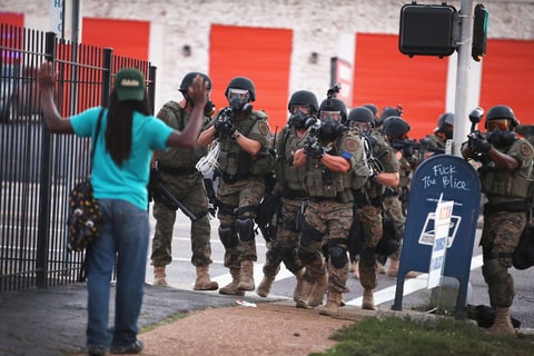 Police force protestors from the business district into nearby neighborhoods on August 11, 2014 in Ferguson, Missouri. Police responded with tear gas and rubber bullets as residents and their supporters protested the shooting by police of an unarmed black teenager named Michael Brown who was killed Saturday in this suburban St. Louis community. Yesterday 32 arrests were made after protests turned into rioting and looting in Ferguson.