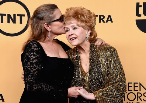 Actress Carrie Fisher (L) and honoree Debbie Reynolds pose in the press room at the 21st Annual Screen Actors Guild Awards at The Shrine Auditorium on January 25, 2015 in Los Angeles, California.
