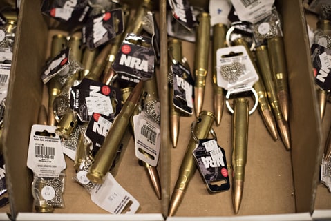 National Rifle Association (NRA) merchandise sits on display during the 144th NRA Annual Meetings and Exhibits at the Music City Center in Nashville, Tennessee, U.S., on Saturday, April 11, 2015. Top Republican contenders for their party's 2016 presidential nomination are lining up to speak at the annual NRA event, except New Jersey Governor Chris Christie and Kentucky Senator Rand Paul, who were snubbed by the country's largest and most powerful gun lobby