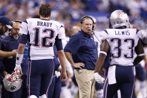 Head coach Bill Belichick of the New England Patriots looks at Tom Brady #12 as he comes off the field during a game against the Indianapolis Colts at Lucas Oil Stadium on October 18, 2015 in Indianapolis, Indiana. The Patriots defeated the Colts 34-27.