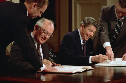 President Ronald Reagan and Soviet General Secretary Mikhail Gorbachev signing the arms control agreement banning the use of intermediate-range nuclear missles, the Intermediate Nuclear Forces Reduction Treaty.