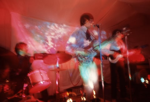 Nick Mason, Roger Waters and Syd Barrett of Pink Floyd perform under psychedelic lighting at the Architectural Association student party, London, 16th December 1966.