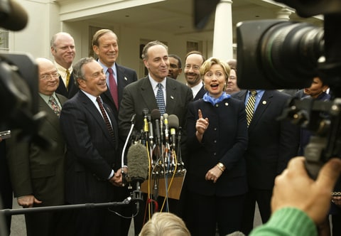 Holding a press conference outside of the White House are New York senator Charles Schumer, New York Governor George Pataki, New York City mayor Michael Bloomberg, and New York senator Hillary Clinton. The group are thanking President George Bush for supporting a $21.4 billion September 11 recovery package for their state.