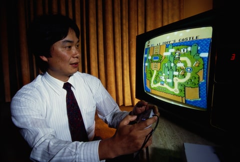 Shigeru Miyamoto, creator of Mario and other characters and video games for Nintendo, plays Super Mario World on a Nintendo Super NES System.
