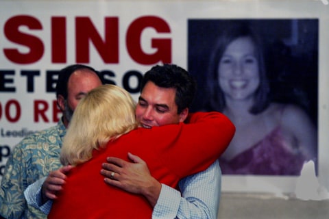 Scott Peterson gets a hug from his sister in law Alison Peterson from San Diego who arrived to help