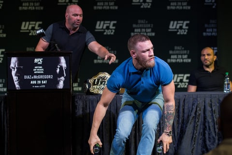 UFC Featherweight champion Conor McGregor grabs two cans during the during the UFC 202 press conference on August 17th, 2016 in Las Vegas, Nevada.