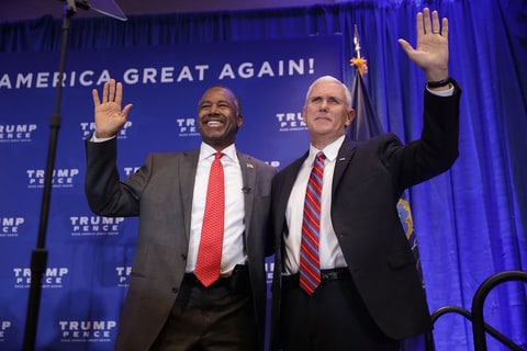Dr. Ben Carson (L) and Republican vice presidential nominee Governor Mike Pence wave during a campaign event at the DoubleTree by Hilton November 1, 2016 in Valley Forge, Pennsylvania. Pence and presidential nominee Donald Trump both highlighted what they see as the failures of Obamacare.