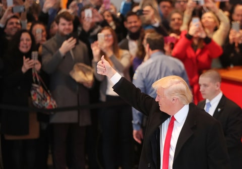 President-elect Donald Trump gives a thumbs up to the crowd as he walks through the lobby of the New York Times following a meeting with editors at the paper on November 22, 2016 in New York City. Trump, who has held meetings with media executives over the last few days, has often had a tense relationship with many mainstream media outlets.