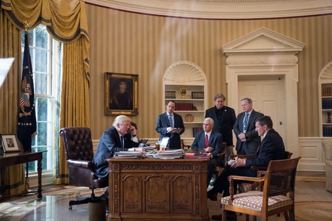 President Donald Trump speaks on the phone with Russian President Vladimir Putin in the Oval Office of the White House, January 28, 2017 in Washington, DC. Also pictured, from left, White House Chief of Staff Reince Priebus, Vice President Mike Pence, White House Chief Strategist Steve Bannon, Press Secretary Sean Spicer and National Security Advisor Michael Flynn.