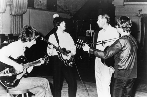 Rock and roll band 'The Beatles' pose for a portrait in the studio with their producer George Martin in cicra 1964.
