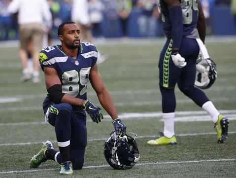 Wide receiver Doug Baldwin #89 of the Seattle Seahawks kneels on the field before the game against the Indianapolis Colts at CenturyLink Field on October 1, 2017 in Seattle, Washington.