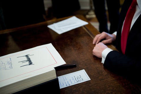 The tax-reform bill after being signed by Trump in the Oval Office