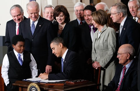 President Barack Obama signs the Affordable Health Care for America Act during a ceremony with fellow Democrats in the East Room of the White House March 23, 2010 in Washington, DC. The historic bill was passed by the House of Representatives Sunday after a 14-month-long political battle that left the legislation without a single Republican vote.