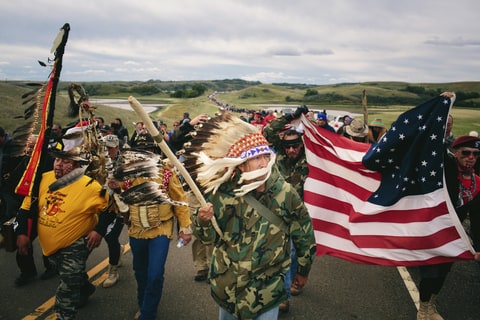 Catcher Cuts The Road, an Iraq War veteran, leads a protest march to a sacred burial ground at the Standing Rock Indian Reservation in North Dakota, Sept. 9, 2016. A federal judge on Friday denied the Standing Rock Sioux Tribe's efforts to halt the construction of a pipeline skirting the northern edge of the reservation on Friday; on the same day, the government ordered a the pipeline company to pause its work. (