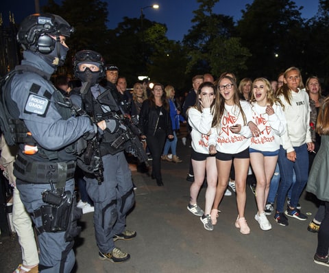 .Fans and armed police at the One Love concert, Manchester
