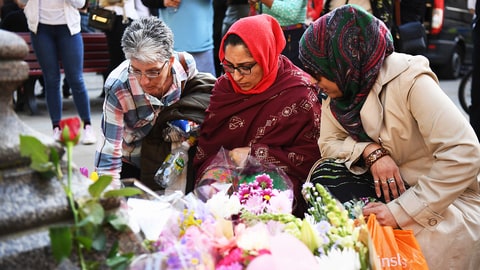 MANCHESTER, ENGLAND - MAY 23: Members of the public light candles during a candlelit vigil, to honour the victims of Monday evening's terror attack, at Albert Square on May 23, 2017 in Manchester, England. Monday's explosion occurred at Manchester Arena as concert goers were leaving the venue after Ariana Grande had just finished performing. Greater Manchester Police are treating the explosion as a terrorist attack and have confirmed 22 fatalities and 59 injured. (Photo by Leon Neal/Getty Images)