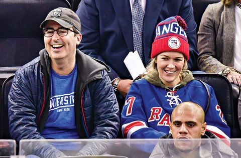 Oliver with his wife, Kate Norley, at a New York Rangers game.