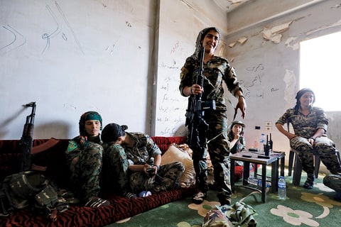 Young members of the SDF take shelter in an abandoned house. “Age has nothing to do with it,” says one teenage commander. “It’s a matter of will.”