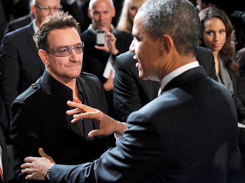 US President Barack Obama (C) chats with muscian Bono (L) as singer Alcia Keys (R) looks on after speaking at a World AIDS Day event December 1, 2011 at George Washington University in Washington, DC.
