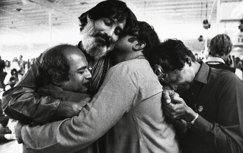 Followers of the Bhagwan Shree Rajneesh embrace during a meditation session on at Rajneeshpuram in central Oregon, 1984.