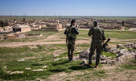 Kurdish People's Protection Units (YPG) fighters stand with their weapons in Tel Hamis in Hasaka countryside March 1, 2015. Kurdish forces dealt a blow to Islamic State by capturing Tel Hamis, an important town, on Friday in the latest stage of a powerful offensive in northeast Syria, a Kurdish militia spokesman said. The capture of Tel Hamis was announced by the Kurdish YPG militia and confirmed by the Syrian Observatory for Human Rights, which monitors the country's civil war.