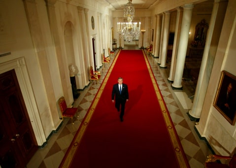 U.S. President George W. Bush walks down the cross hall of the White House prior to a news conference in the East Room, March 6, 2003. Bush said on Thursday it was time for U.N. Security Council members to