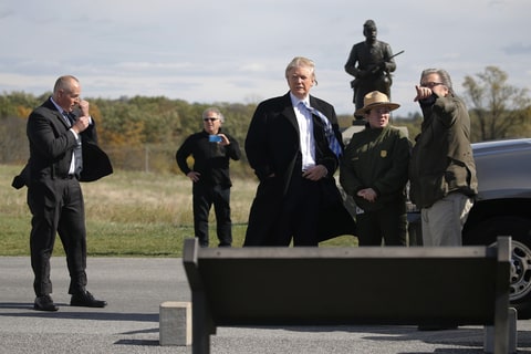 Republican U.S. presidential nominee Donald Trump (C) and campaign CEO Steve Bannon (R) listen to National Park Service Interpretive Park Ranger Caitlin Kostic (2nd R) on a brief visit to Gettysburg National Military Park in Gettysburg, Pennsylvania, U.S. October 22, 2016.
